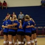 a photo of the volleyball team in a huddle in Hawaii