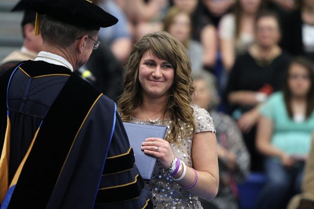 Whitley's sister accepts her diploma at graduation