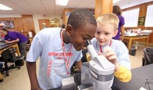 Union elementary students using a microscope